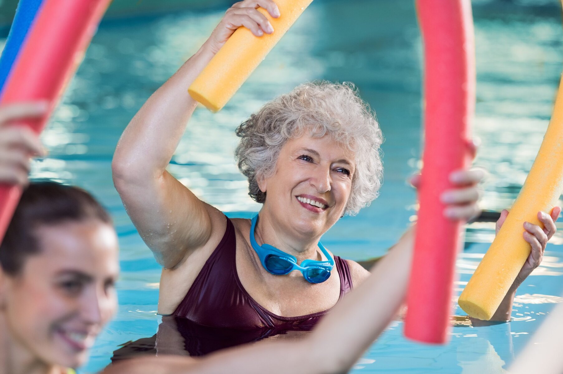 Smiling,Senior,Woman,Doing,Aqua,Fitness,With,Swim,Noodles.,Happy